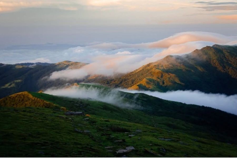 Pikey Peak sunrise over green hills and clouds